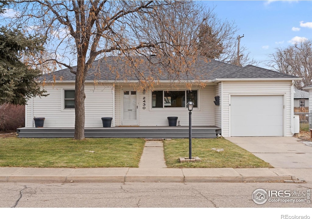 ranch-style house featuring a garage and a front lawn