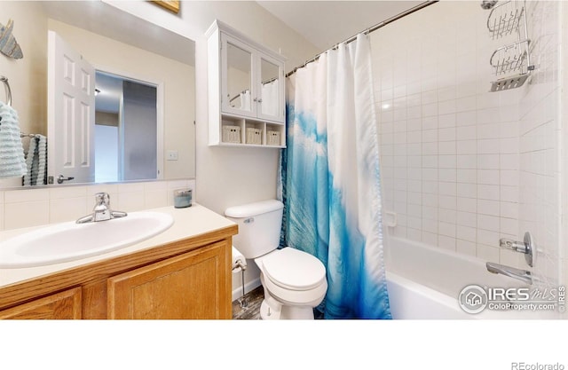 full bathroom featuring toilet, shower / tub combo, backsplash, and vanity