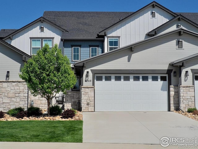 4260 Grand Park Dr, Timnath, CO 80547 - craftsman-style home with stone siding, board and batten siding, concrete driveway, and an attached garage