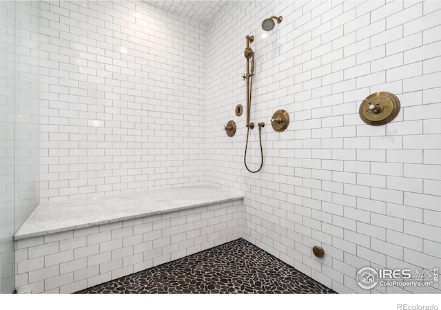 full bath with a tile shower