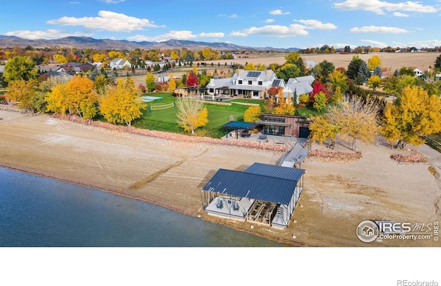 aerial view featuring a water and mountain view