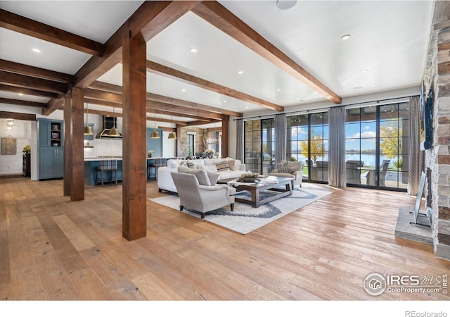 living room with beamed ceiling and wood-type flooring