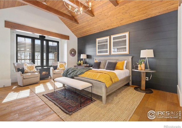 bedroom with an inviting chandelier, beamed ceiling, wood finished floors, and wooden ceiling