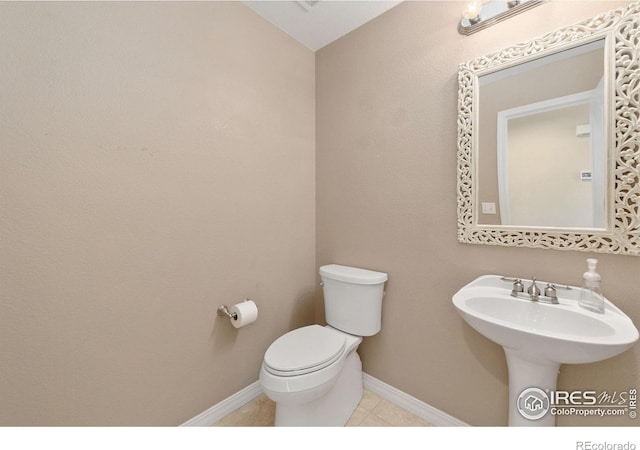 bathroom with tile patterned floors and toilet