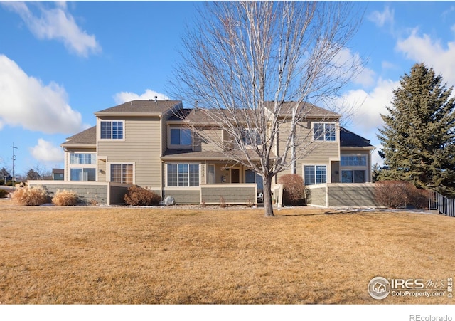 rear view of property featuring a yard