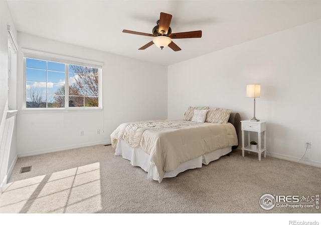 bedroom with baseboards, carpet flooring, and visible vents