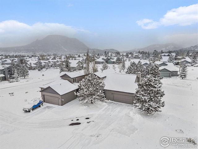 snowy aerial view with a mountain view