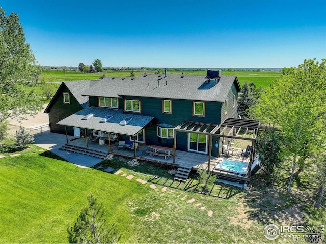 rear view of house with a pergola, a patio area, a yard, a deck, and central AC