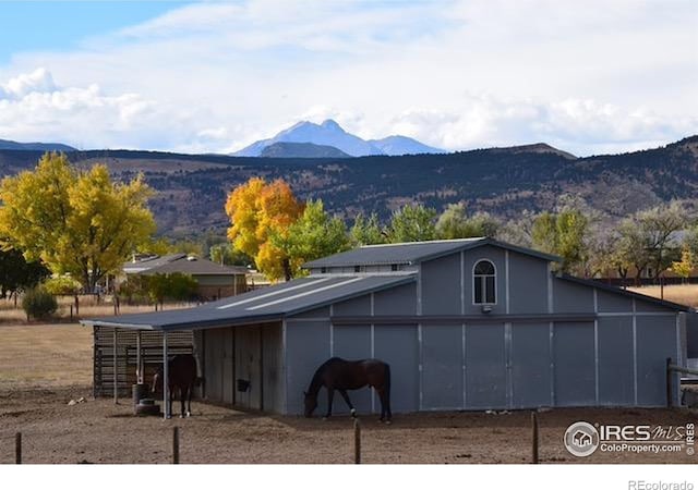 view of horse barn featuring a mountain view