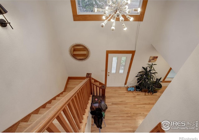 foyer entrance with hardwood / wood-style flooring and a notable chandelier