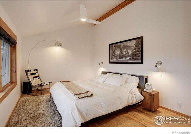 bedroom featuring ceiling fan, wood-type flooring, ornamental molding, and lofted ceiling