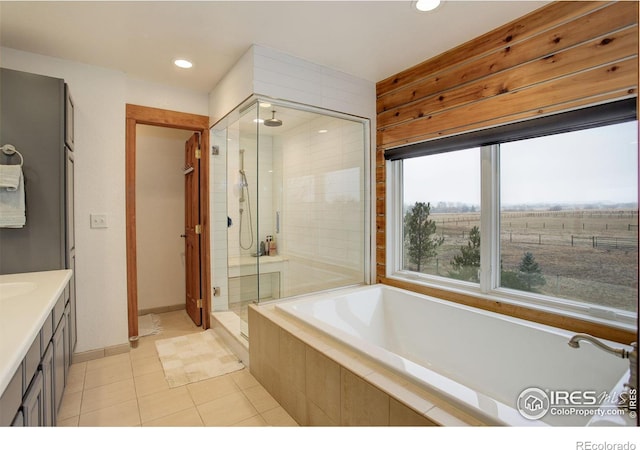 bathroom with vanity, tile patterned floors, and plus walk in shower