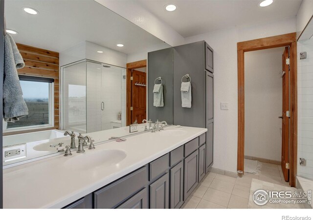 bathroom featuring walk in shower, vanity, and tile patterned floors