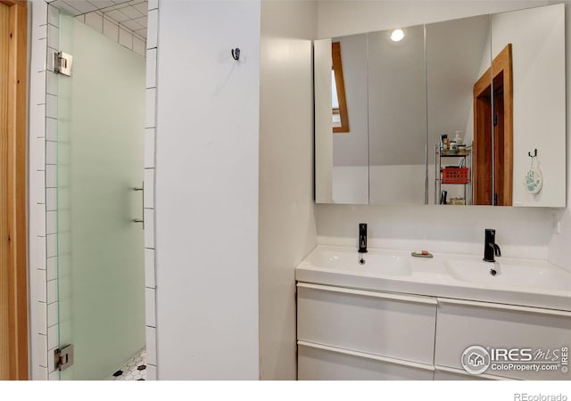 bathroom with an enclosed shower and vanity