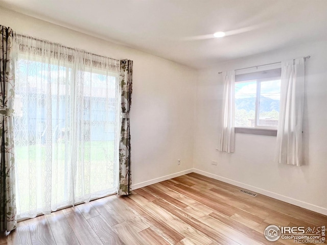 spare room with light hardwood / wood-style floors