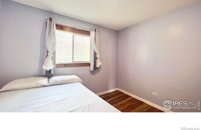 bedroom with hardwood / wood-style flooring