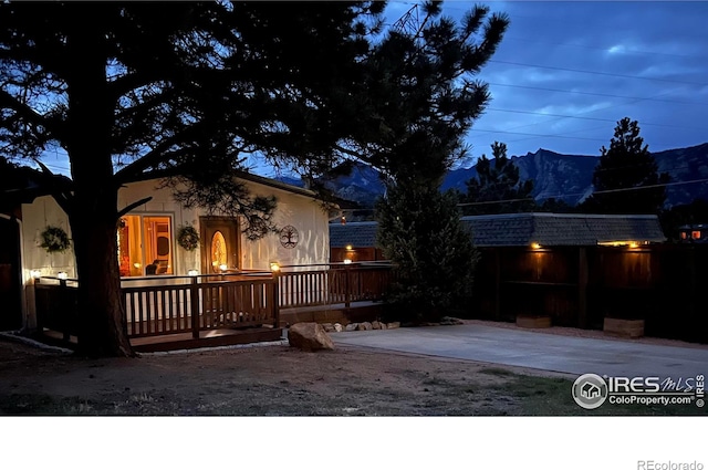 view of front facade featuring a deck with mountain view