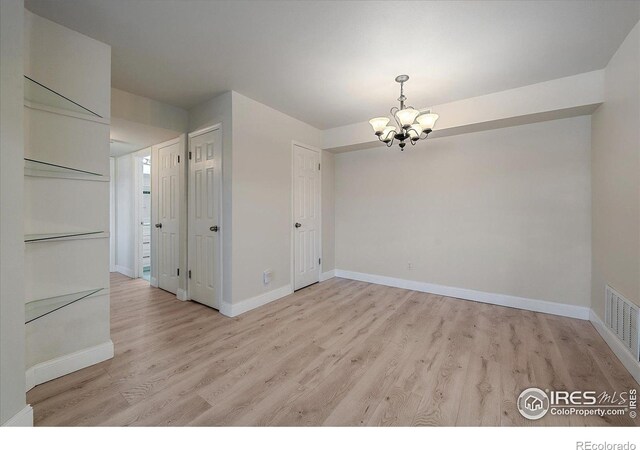 770 Copper Ln Unit 206, Louisville, CO 80027 - unfurnished dining area with light hardwood / wood-style flooring and a notable chandelier