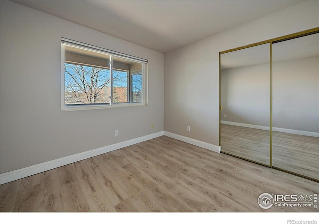 770 Copper Ln Unit 206, Louisville, CO 80027 - unfurnished bedroom featuring a closet and light hardwood / wood-style flooring
