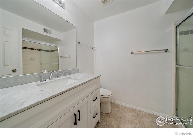 770 Copper Ln Unit 206, Louisville, CO 80027 - bathroom with toilet, vanity, tile patterned flooring, and an enclosed shower