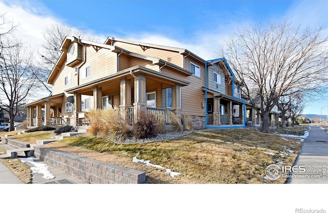 view of side of property with a porch