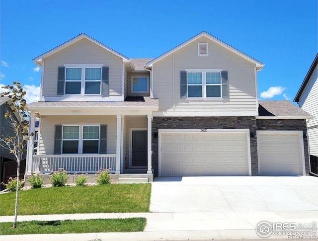 view of front of house featuring covered porch, a front lawn, and a garage