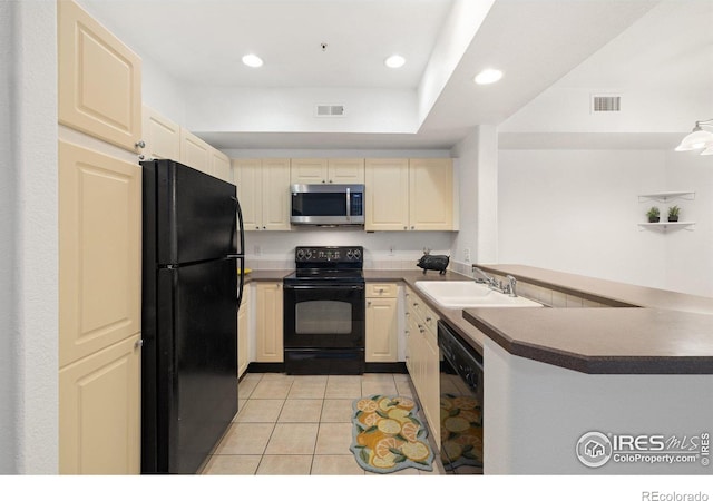 kitchen featuring black appliances, light tile patterned floors, kitchen peninsula, and sink