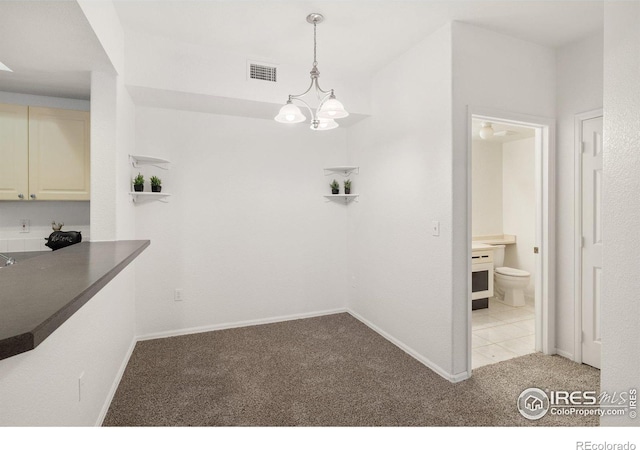 unfurnished dining area with light carpet and a chandelier