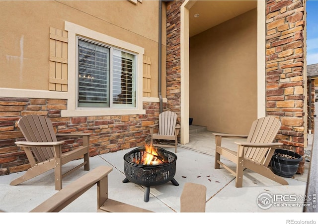 view of patio / terrace with an outdoor fire pit