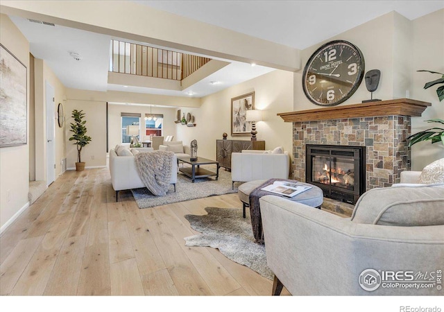 living room featuring light hardwood / wood-style flooring and a fireplace