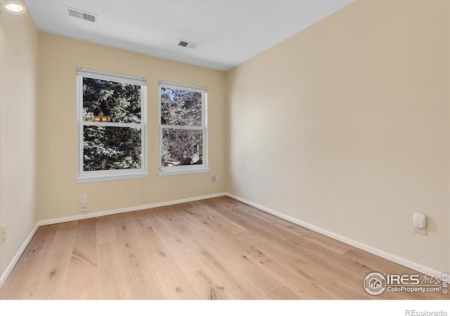 unfurnished room with light hardwood / wood-style floors