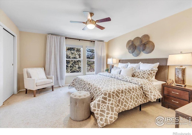 carpeted bedroom with ceiling fan and a closet