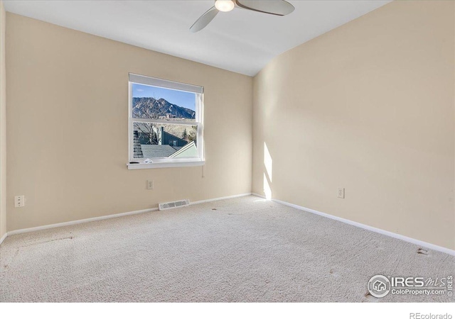 carpeted empty room with ceiling fan