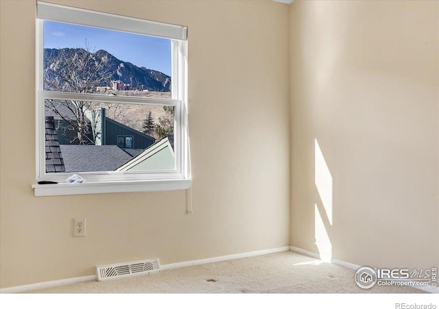 carpeted empty room with a mountain view