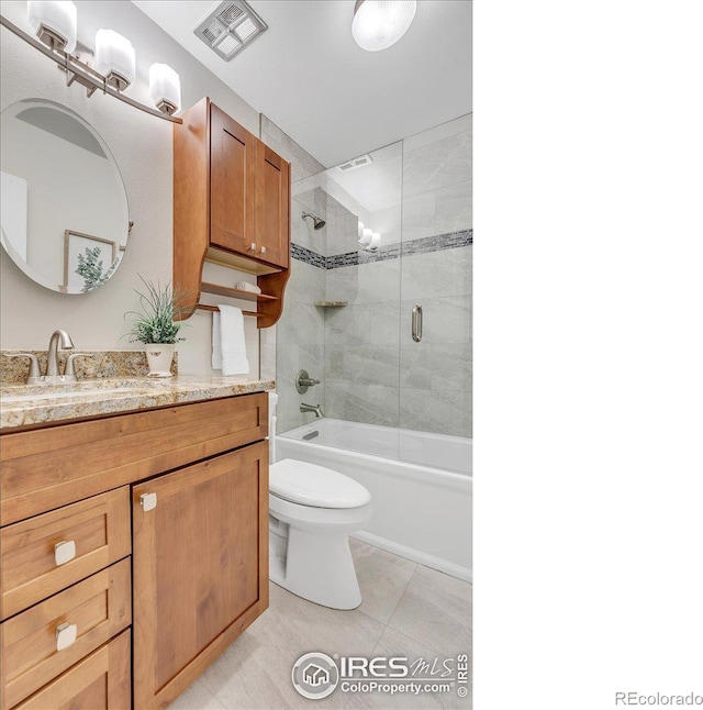 full bathroom featuring toilet, tile patterned flooring, vanity, and shower / bath combination with glass door