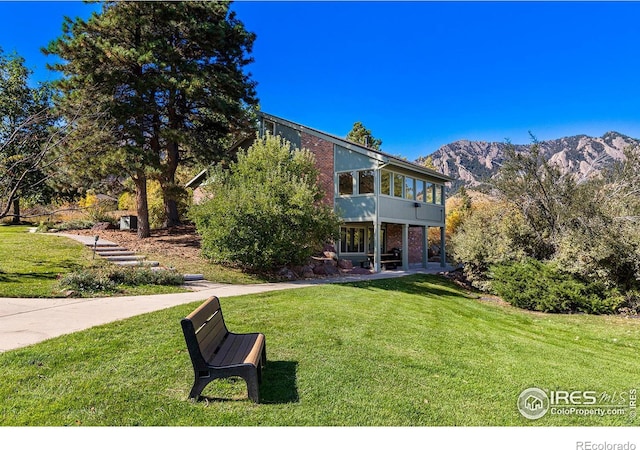 exterior space with a sunroom and a mountain view