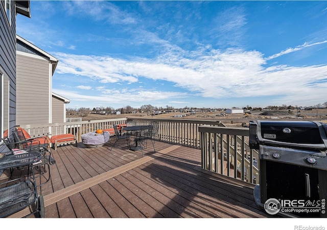 wooden deck with a grill