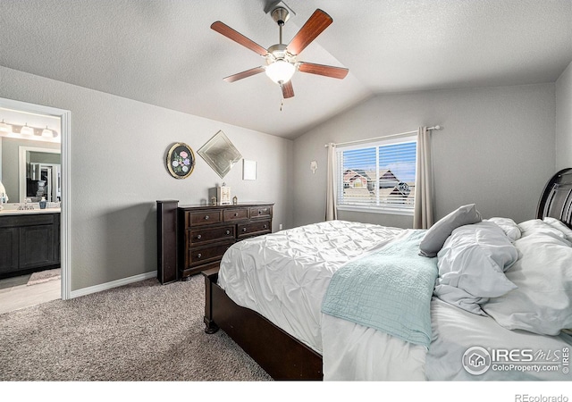 bedroom with light carpet, ceiling fan, connected bathroom, a textured ceiling, and vaulted ceiling