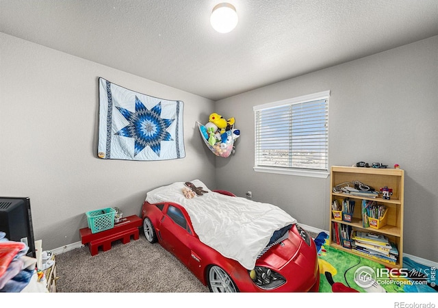 carpeted bedroom featuring a textured ceiling