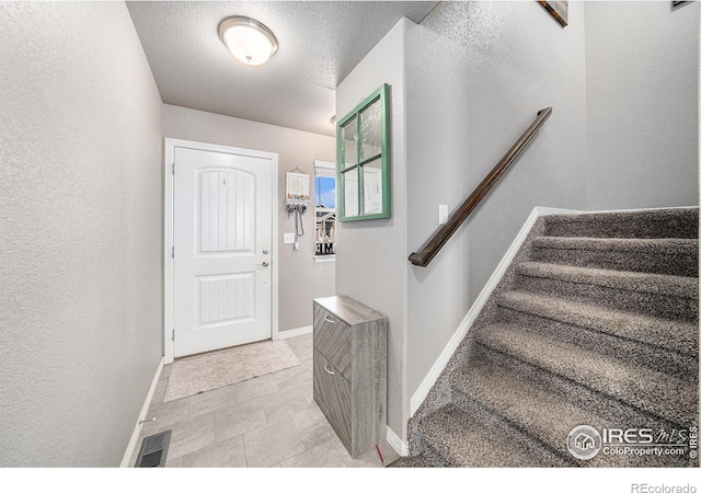 entrance foyer with a textured ceiling