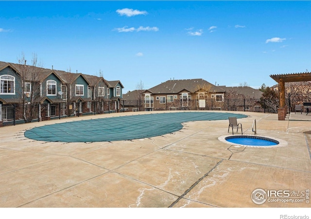 view of swimming pool with a pergola, a patio area, and an in ground hot tub