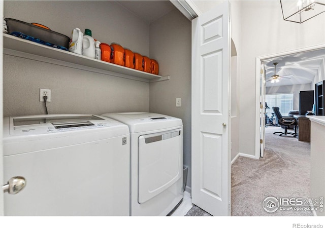 clothes washing area featuring washer and clothes dryer and light colored carpet