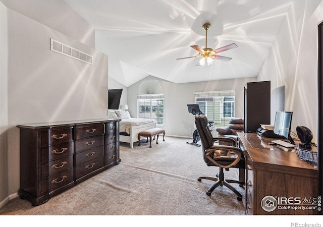 carpeted home office with lofted ceiling and ceiling fan