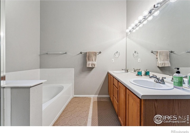 bathroom featuring vanity, tile patterned floors, and a tub