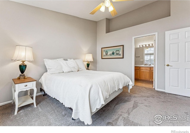 bedroom featuring ceiling fan, carpet, and ensuite bath