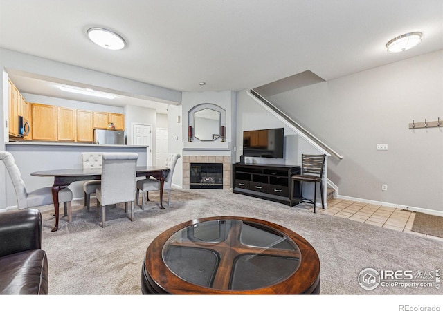 living room featuring light colored carpet and a fireplace