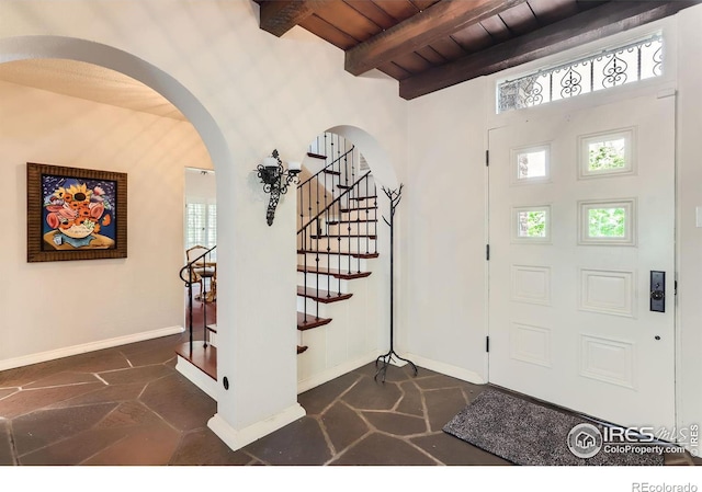 entrance foyer featuring wood ceiling and beamed ceiling