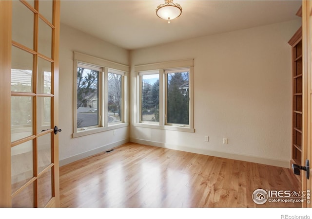 unfurnished room with plenty of natural light and light wood-type flooring