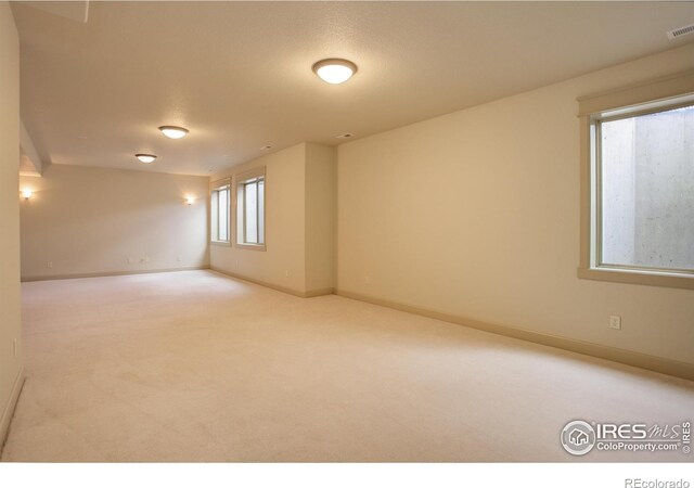 unfurnished room featuring a textured ceiling and carpet flooring