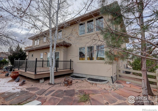 back of house with a wooden deck